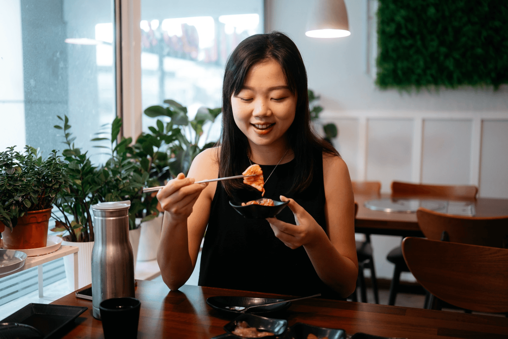Mina plating bulgogi bowls in her kitchen